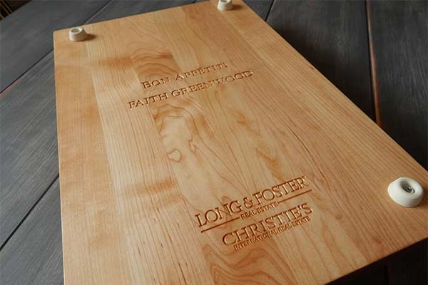 Long & Foster on teh back of a personalized cutting board with rubber feet